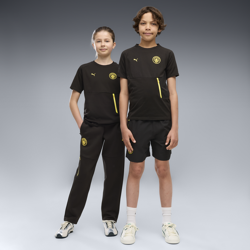 MCFC LW KIDS PUMATECH POCKET TEE - PUMA Black-Yellow Blaze